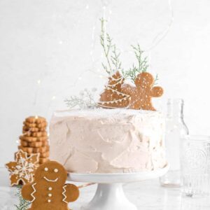 gingerbread cake with powdered sugar drifting down and cookies