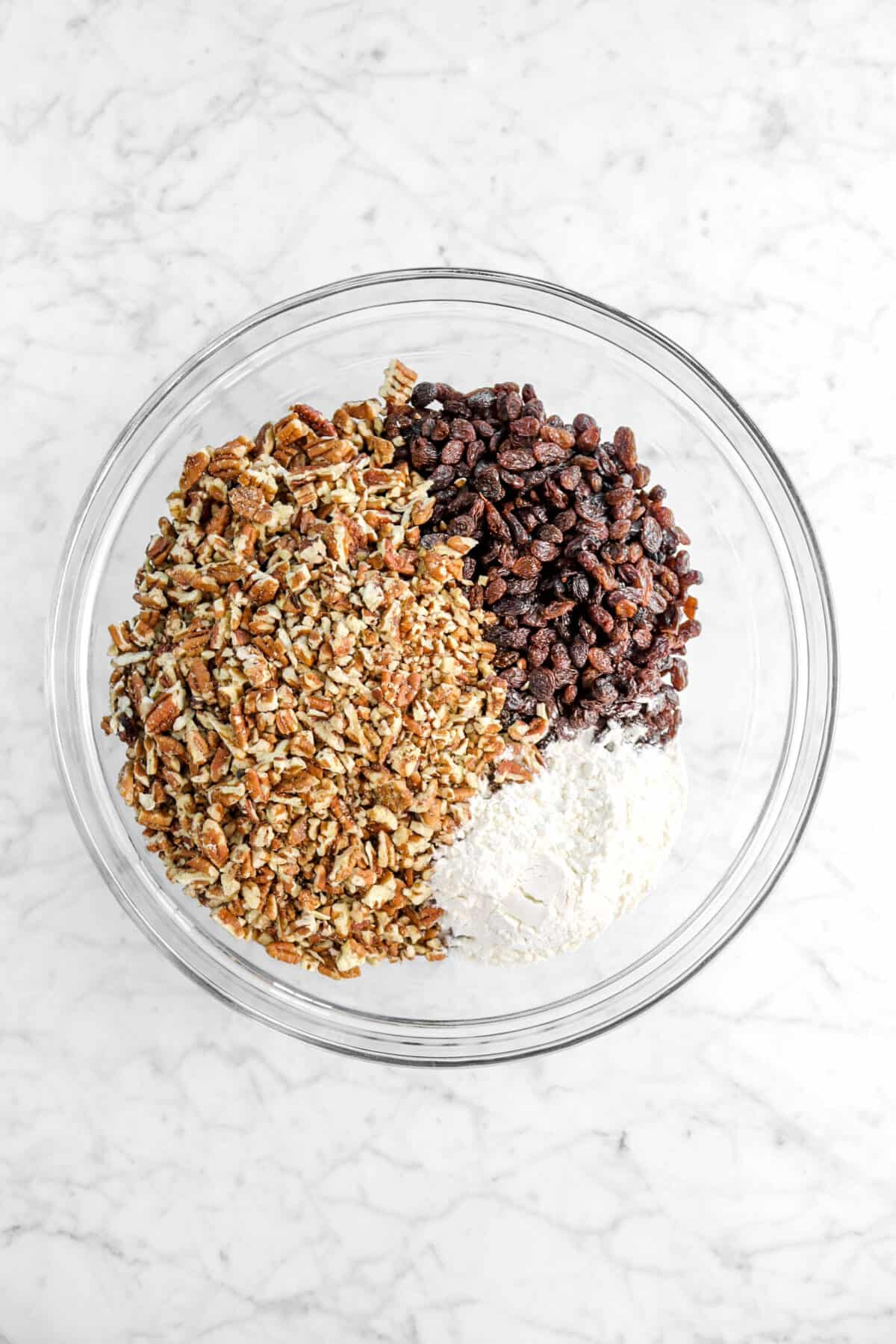 chopped pecans, raisins, and flour in large glass bowl