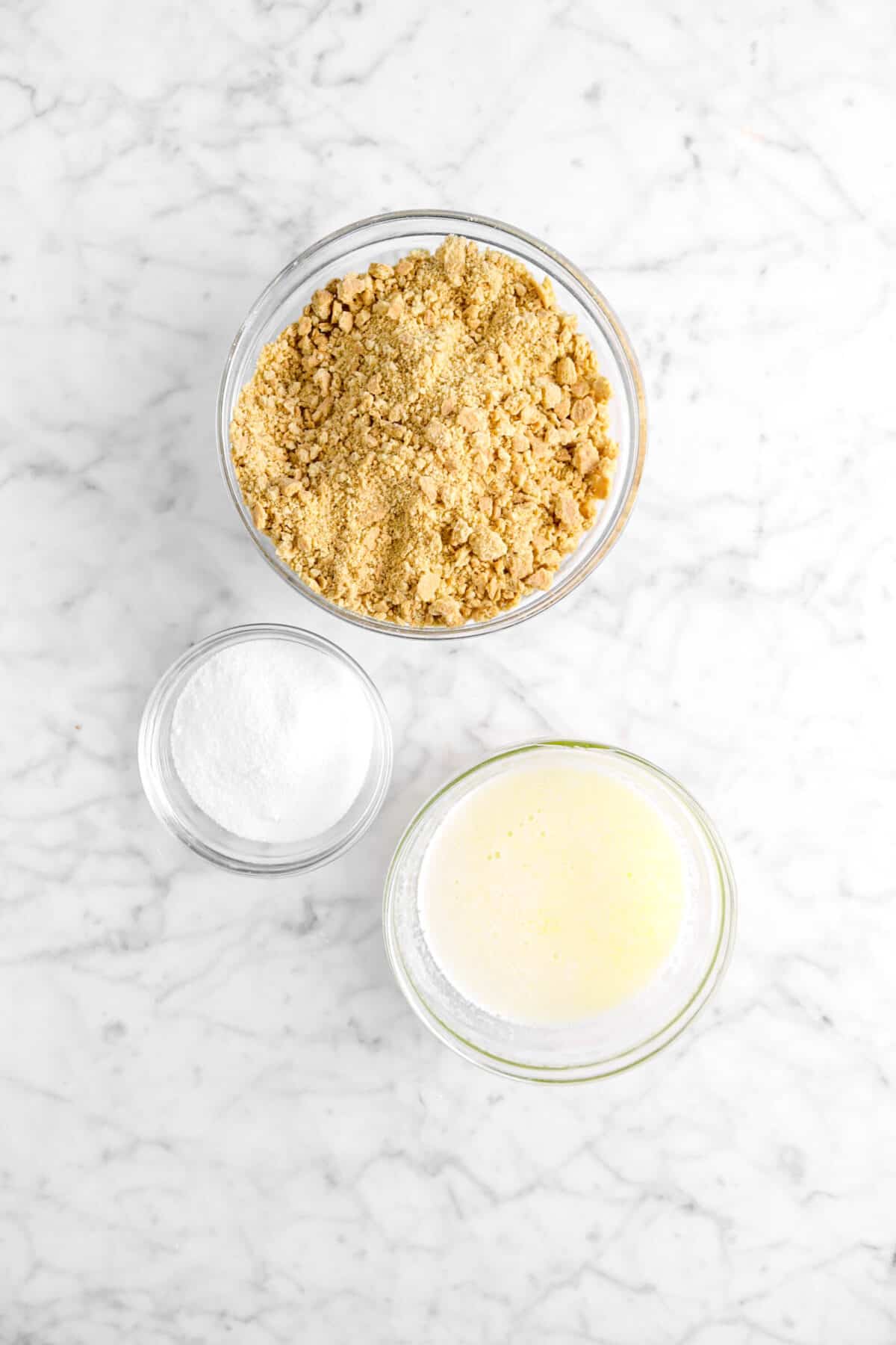 graham cracker crumbs, sugar, and melted butter in glass bowls