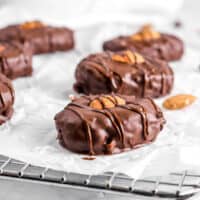 almond joys on parchment with almonds and chocolate chips