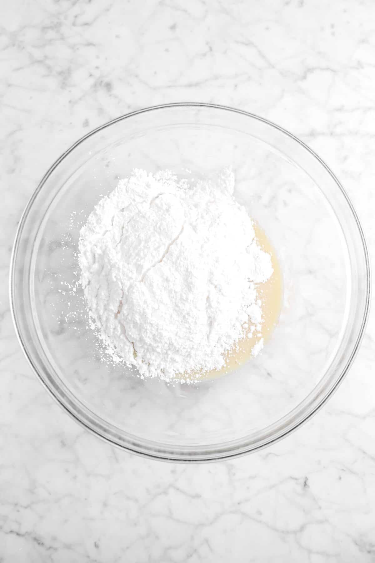 powdered sugar in glass bowl with condensed milk mixture