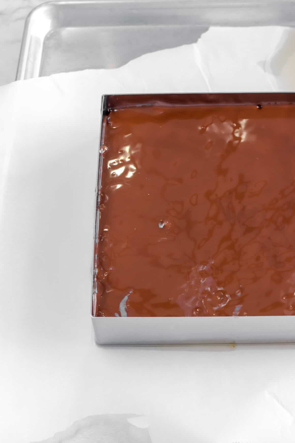 melted chocolate covering granola in square mold