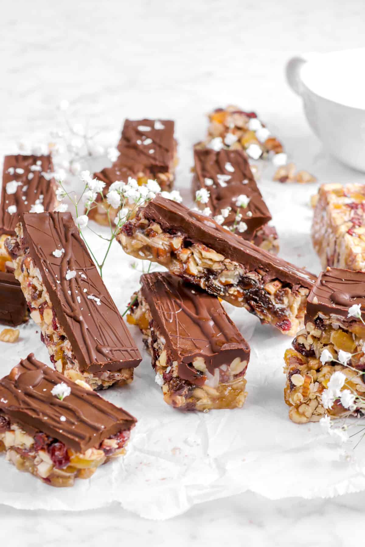 nine granola bars on parchment paper with flowes and a coffee mug