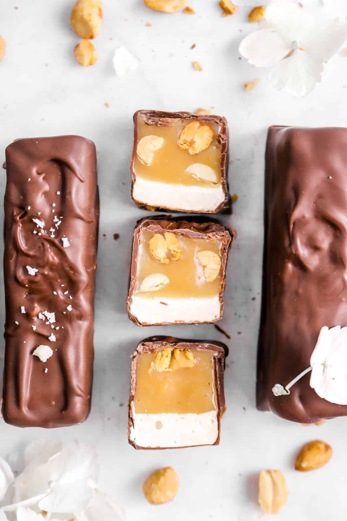 three slices of snickers facing up with two bars beside