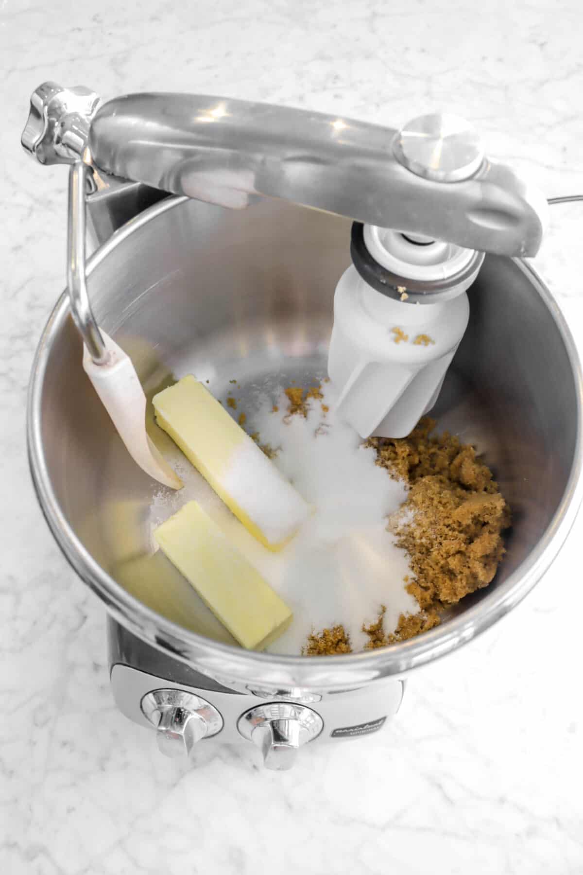 two sticks of butter, white sugar, and brown sugar in a mixer