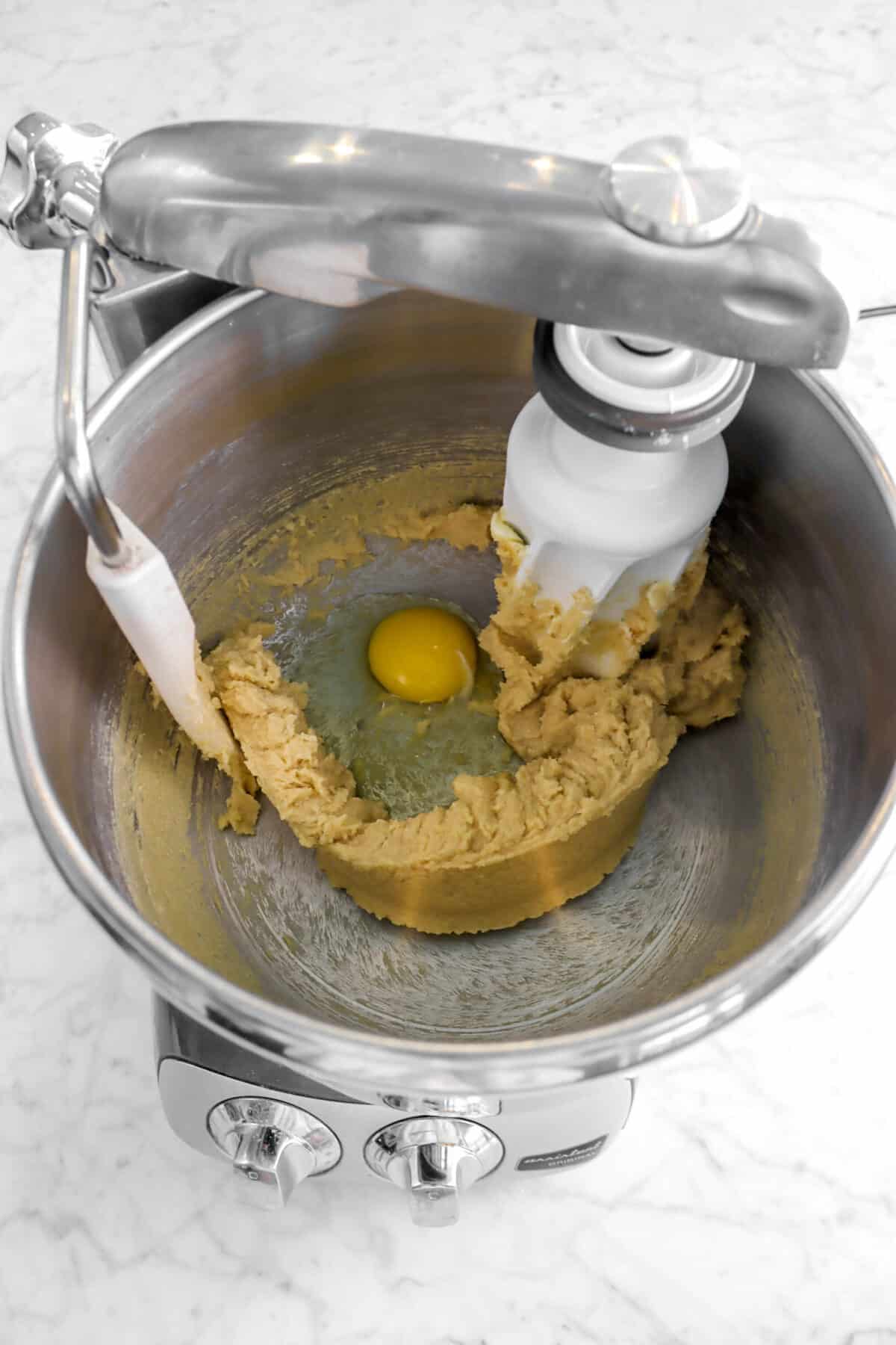 egg in mixer with butter and sugar mixture
