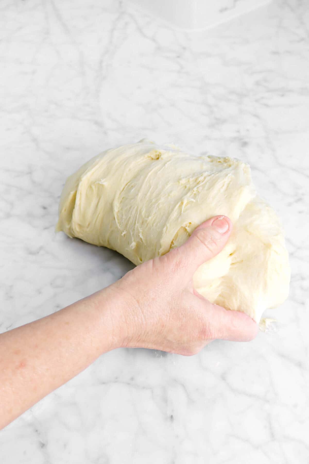 dough folded over with hand under it