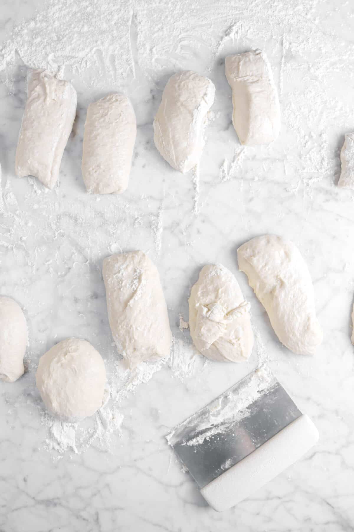 dough cut into nine pieces with pastry knife on marble counter