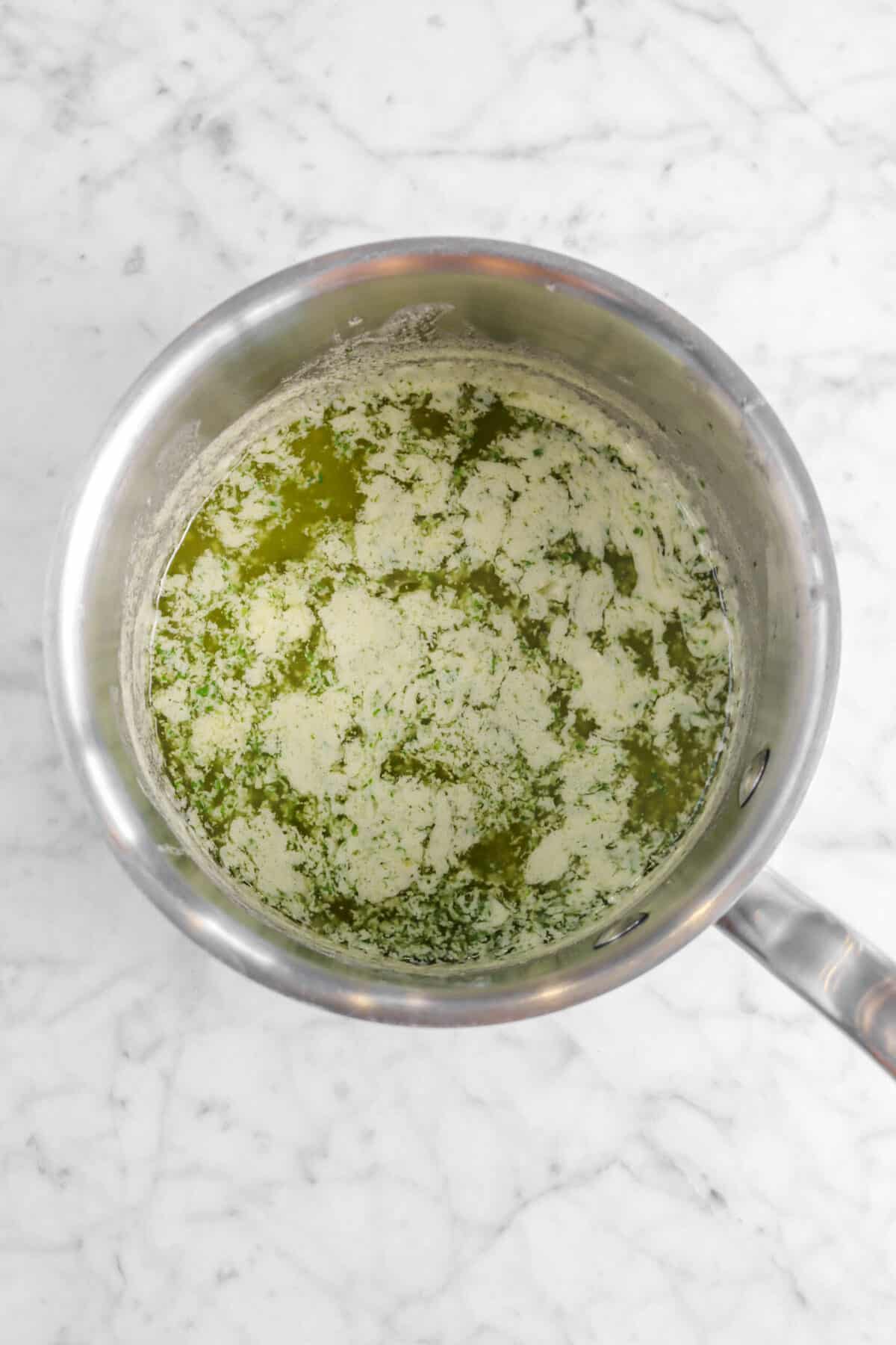 elted garlic herb butter in small pot