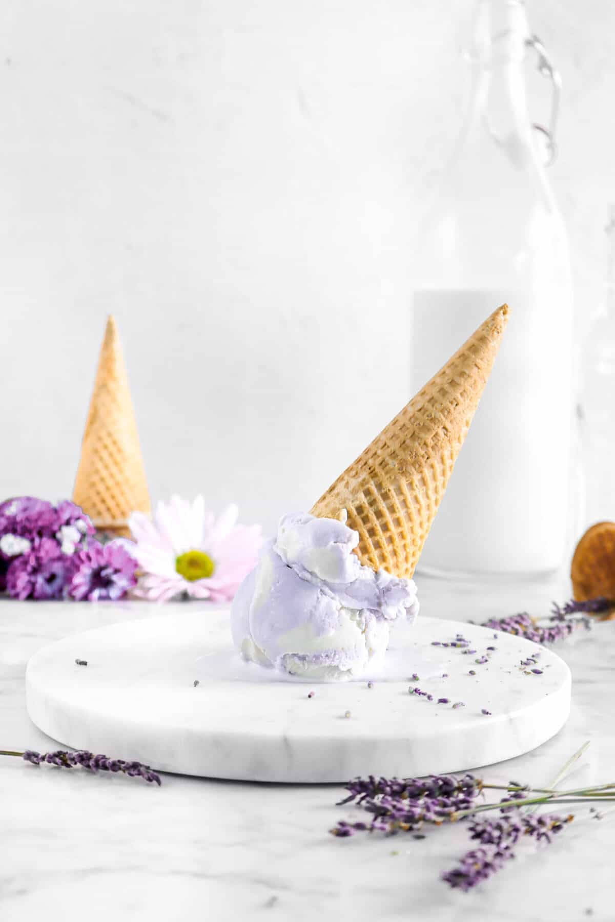 ice cream upside down on marble plate with flowers and glass of milk
