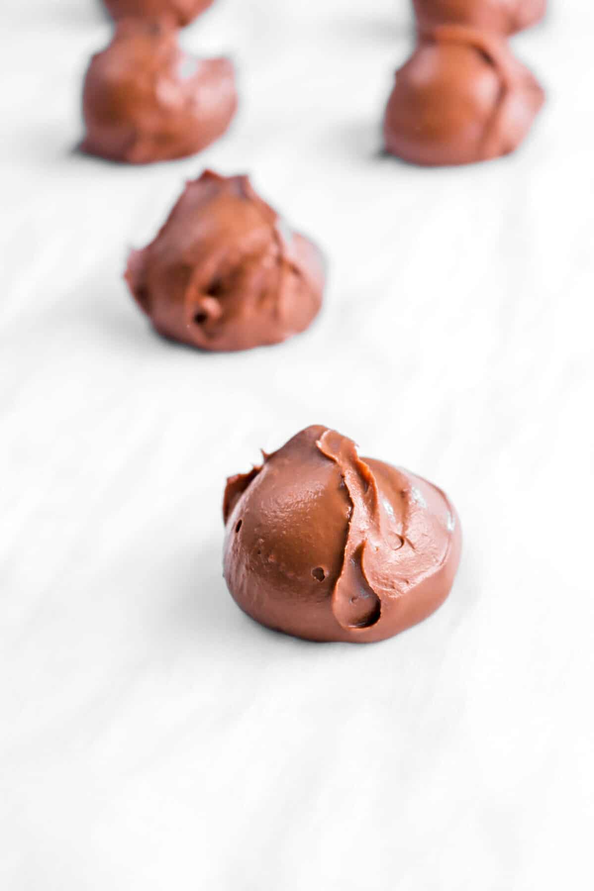 scoops of ganache on parchment paper
