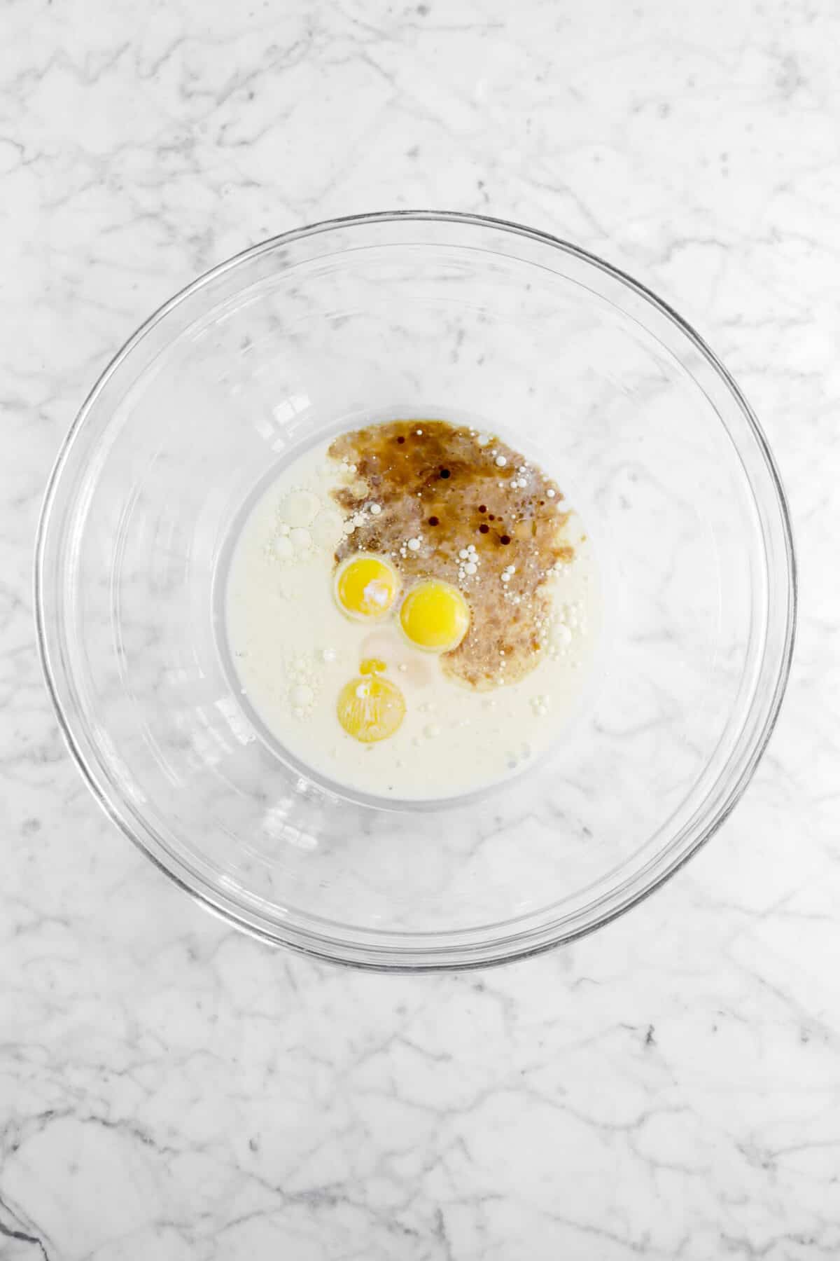 vanilla, egg yolks, oil, and milk in glass bowl