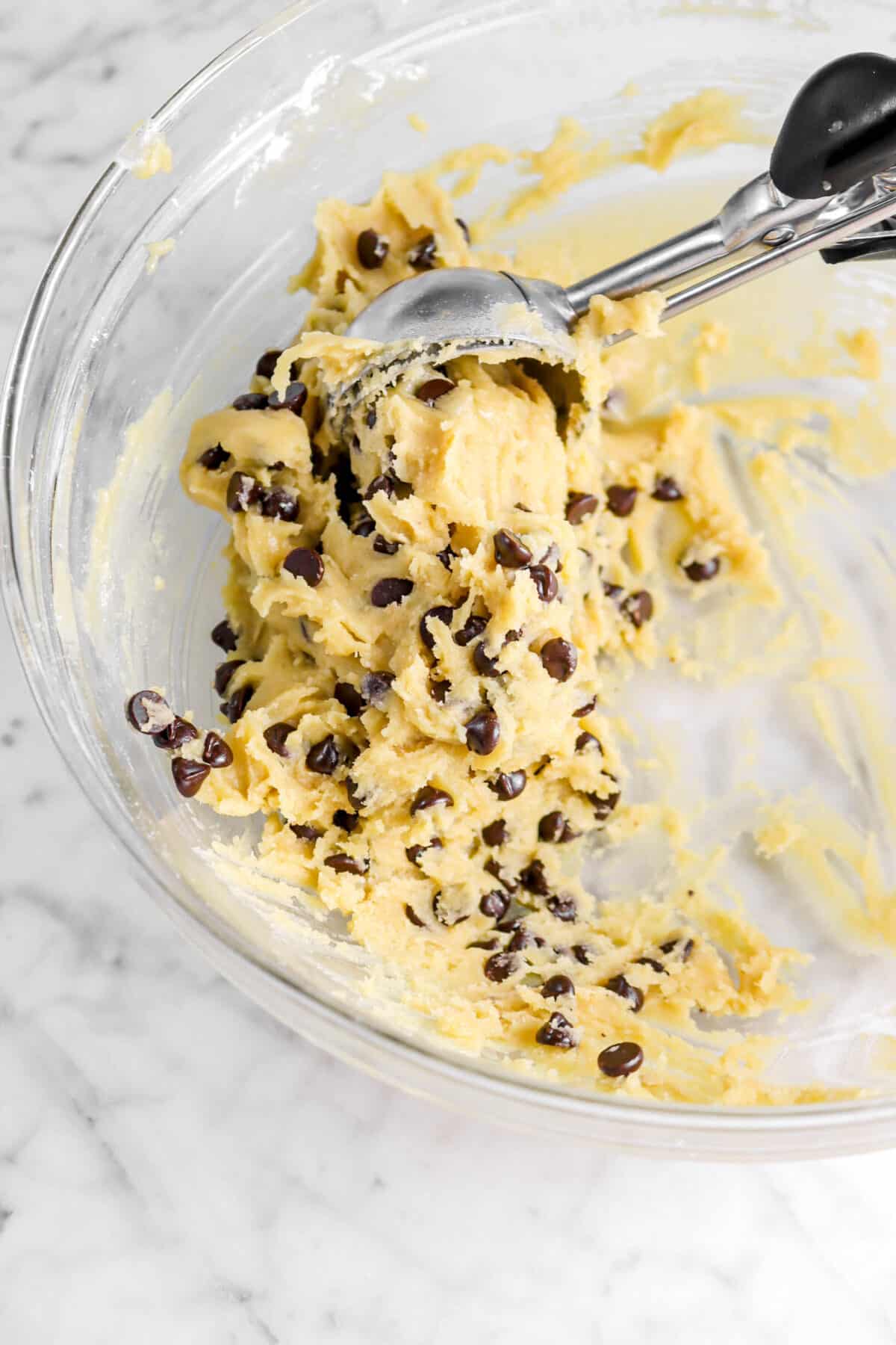 chocolate chip cookie dough being scooped