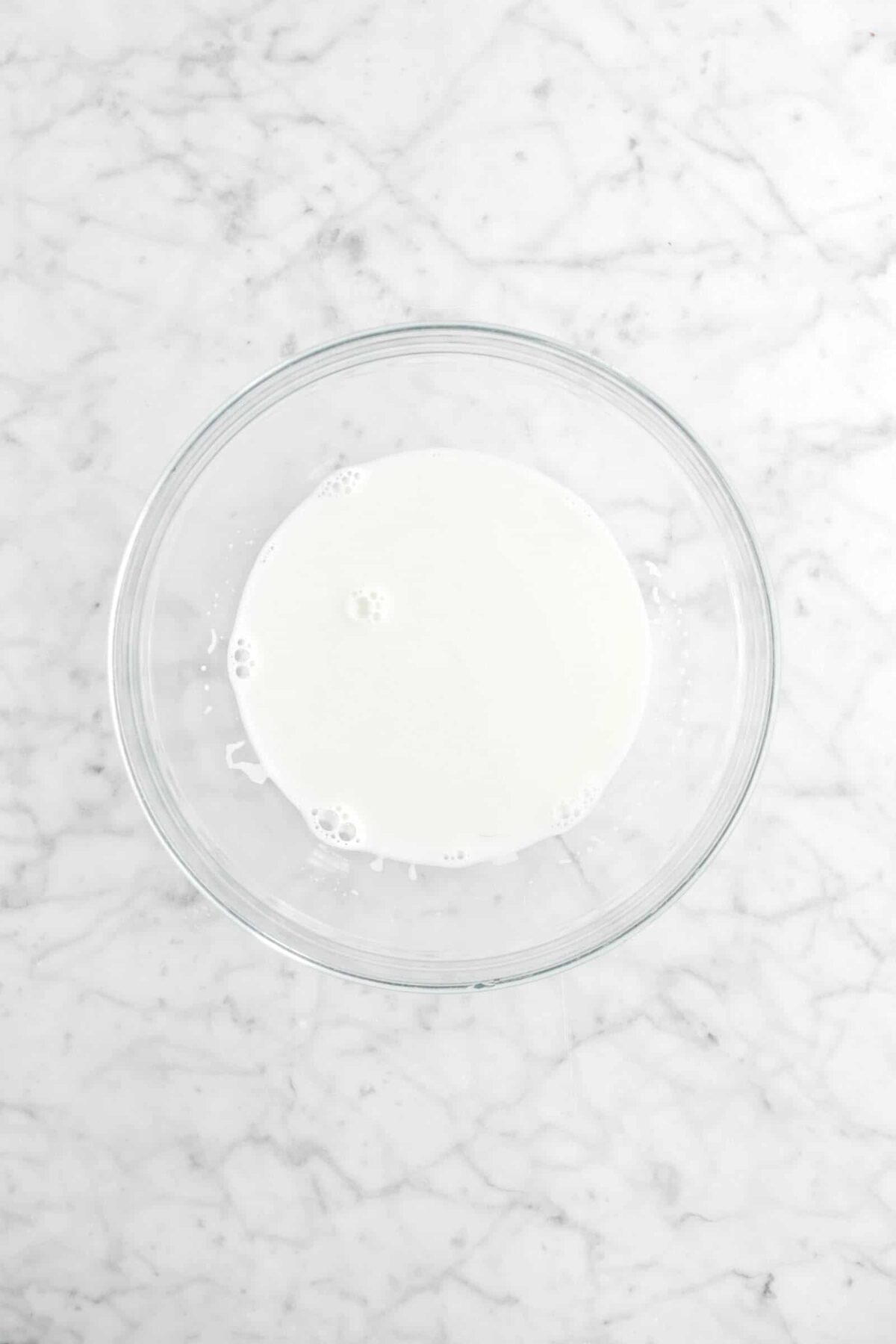 heated milk in glass bowl