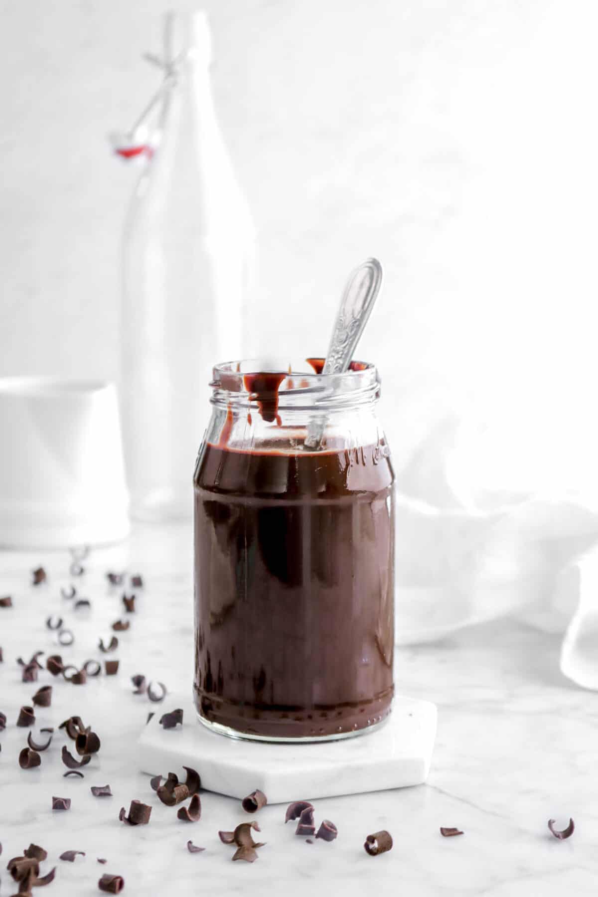 chocolate sauce in small jar with spoon