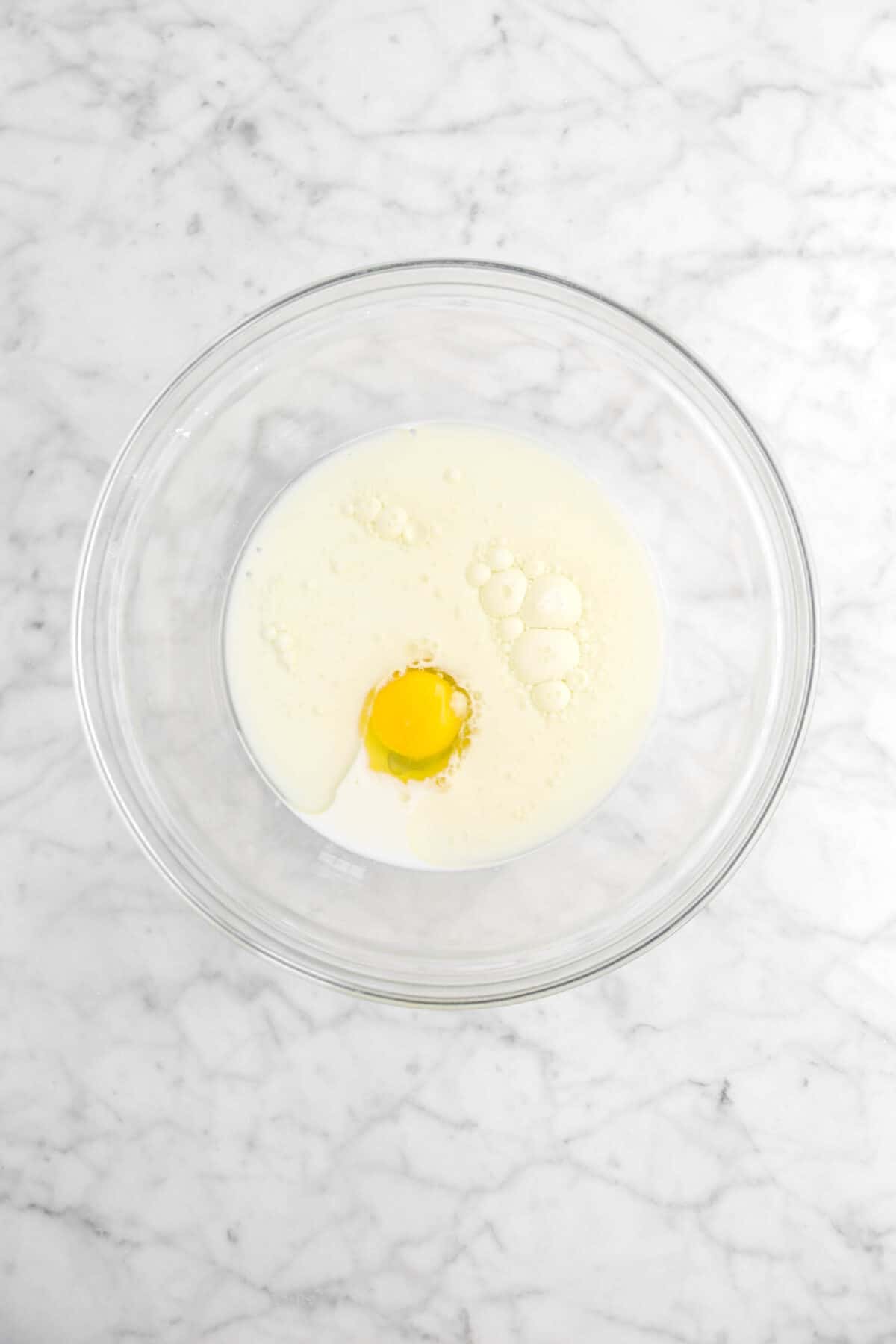 milk, oil, and egg in glass bowl