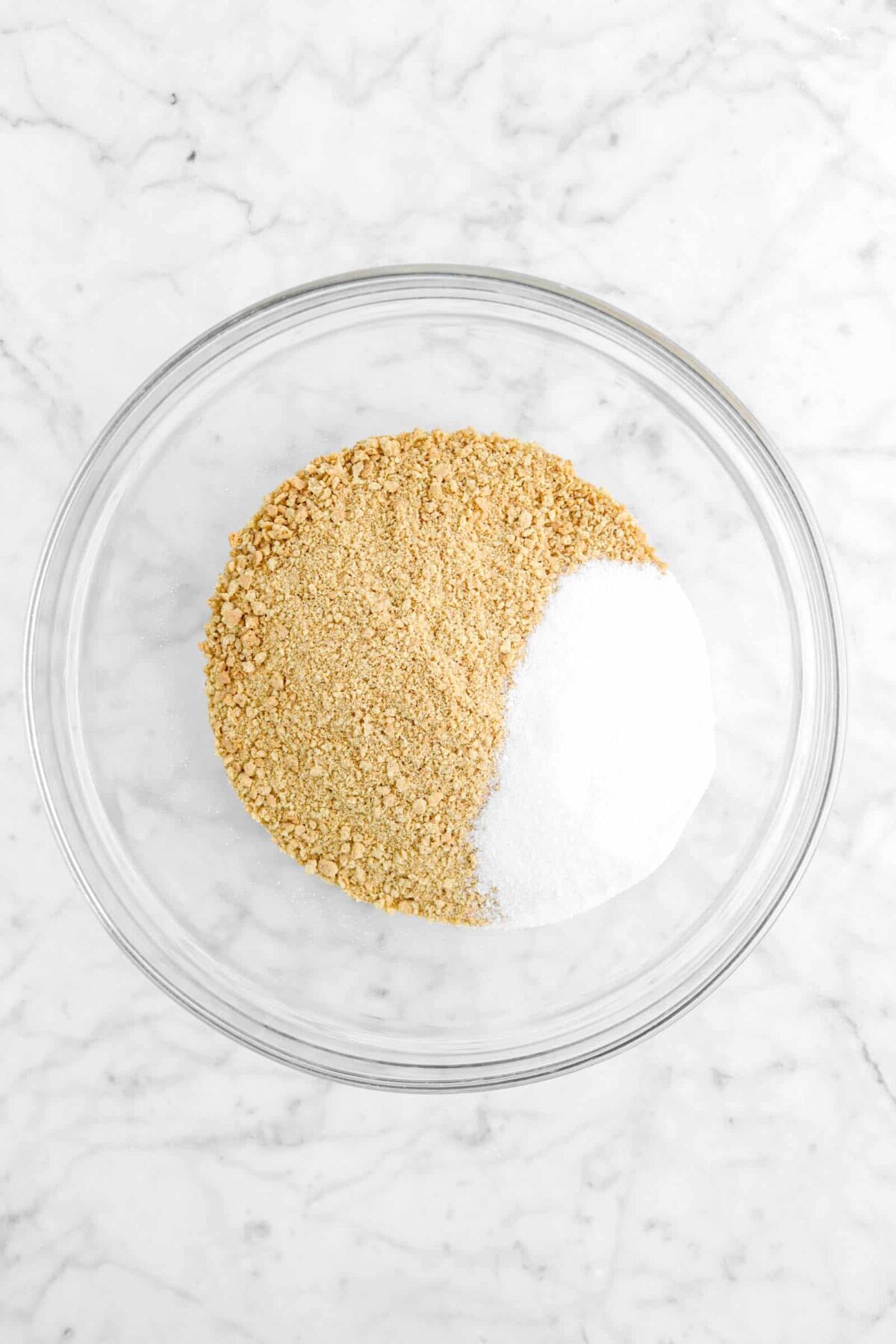 graham cracker crumbs and sugar in glass bowl