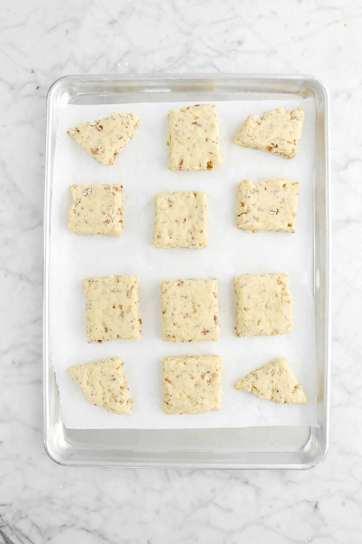 twelve unbaked scones on lined baking sheet