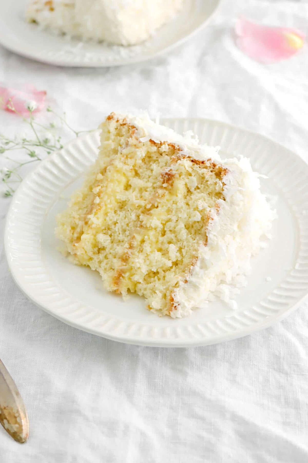 slice of coconut cake on white plate