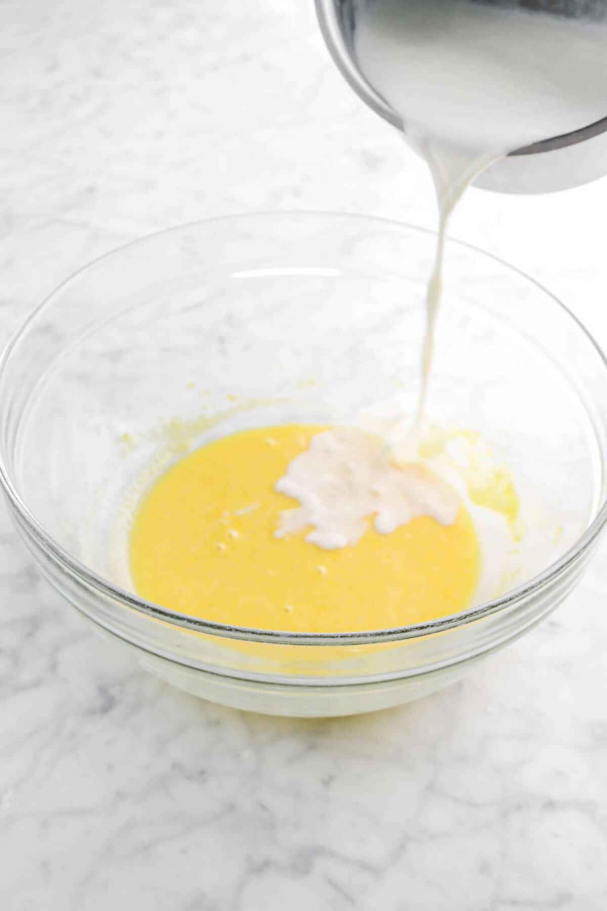 milk being poured into egg mixture