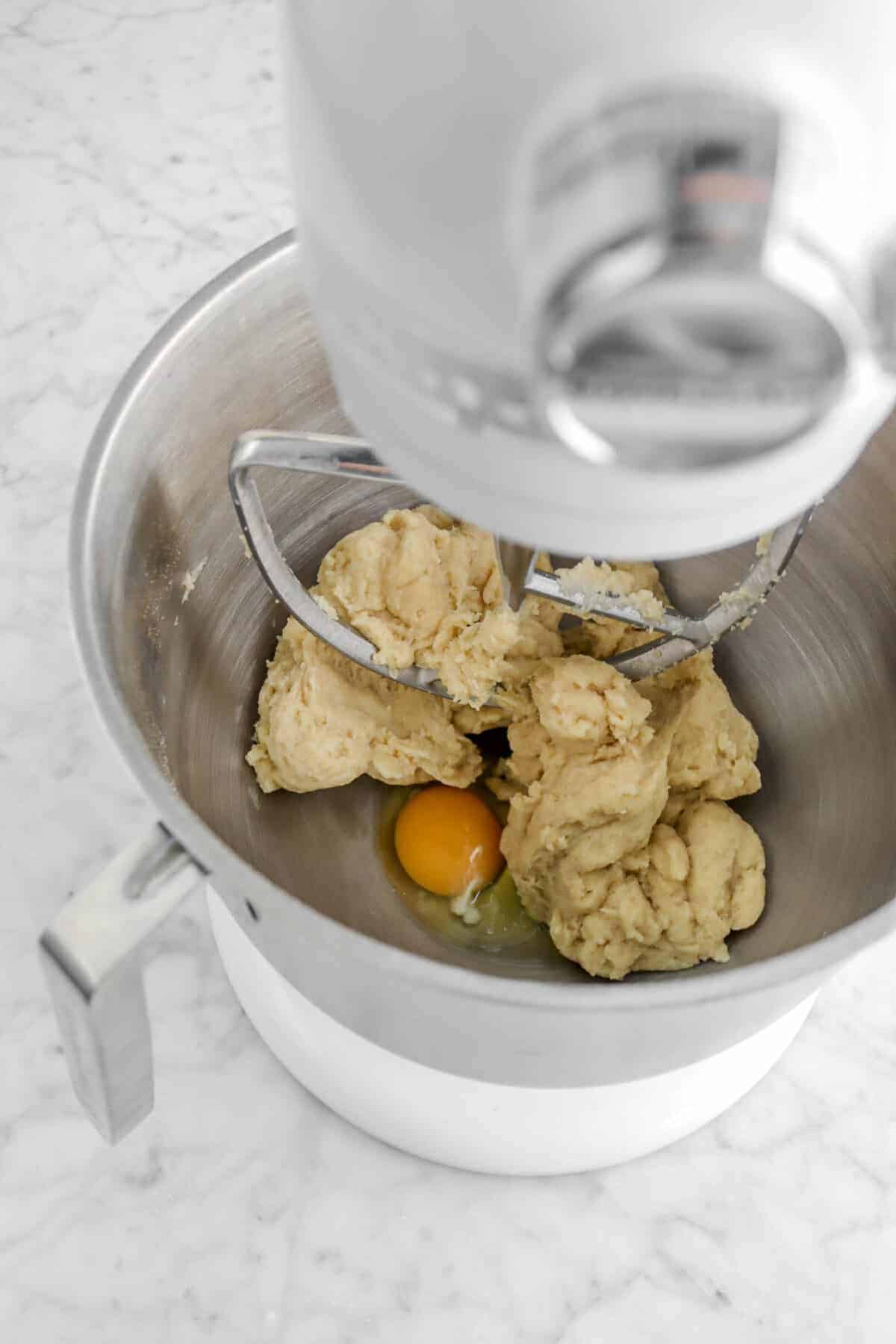 egg added to dough in mixer