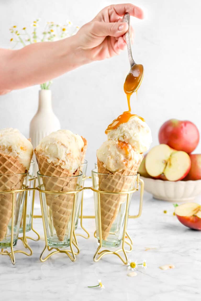 caramel being poured onto double scoop of caramel apple ice cream