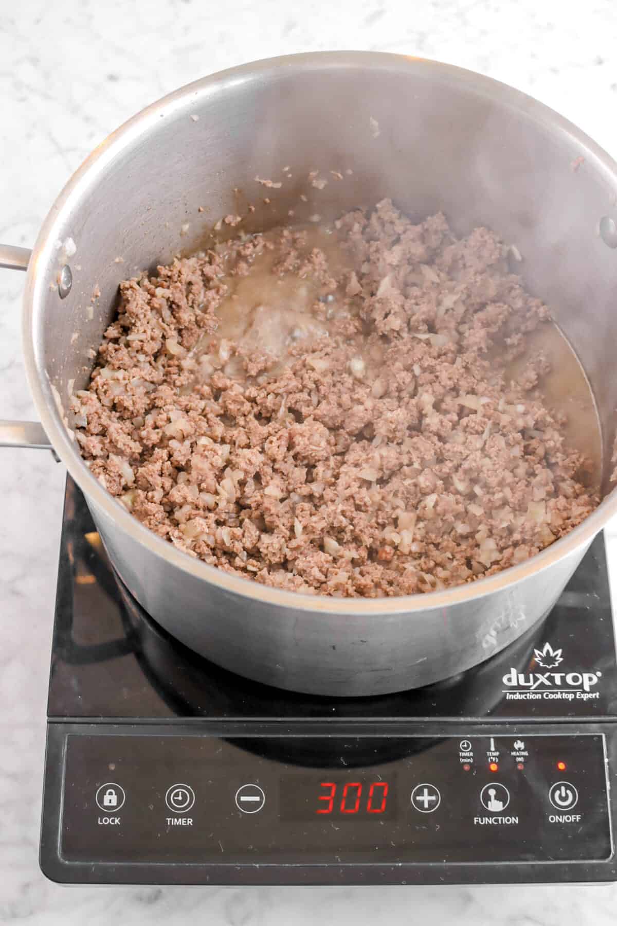 cooked ground beef and onions in a pot