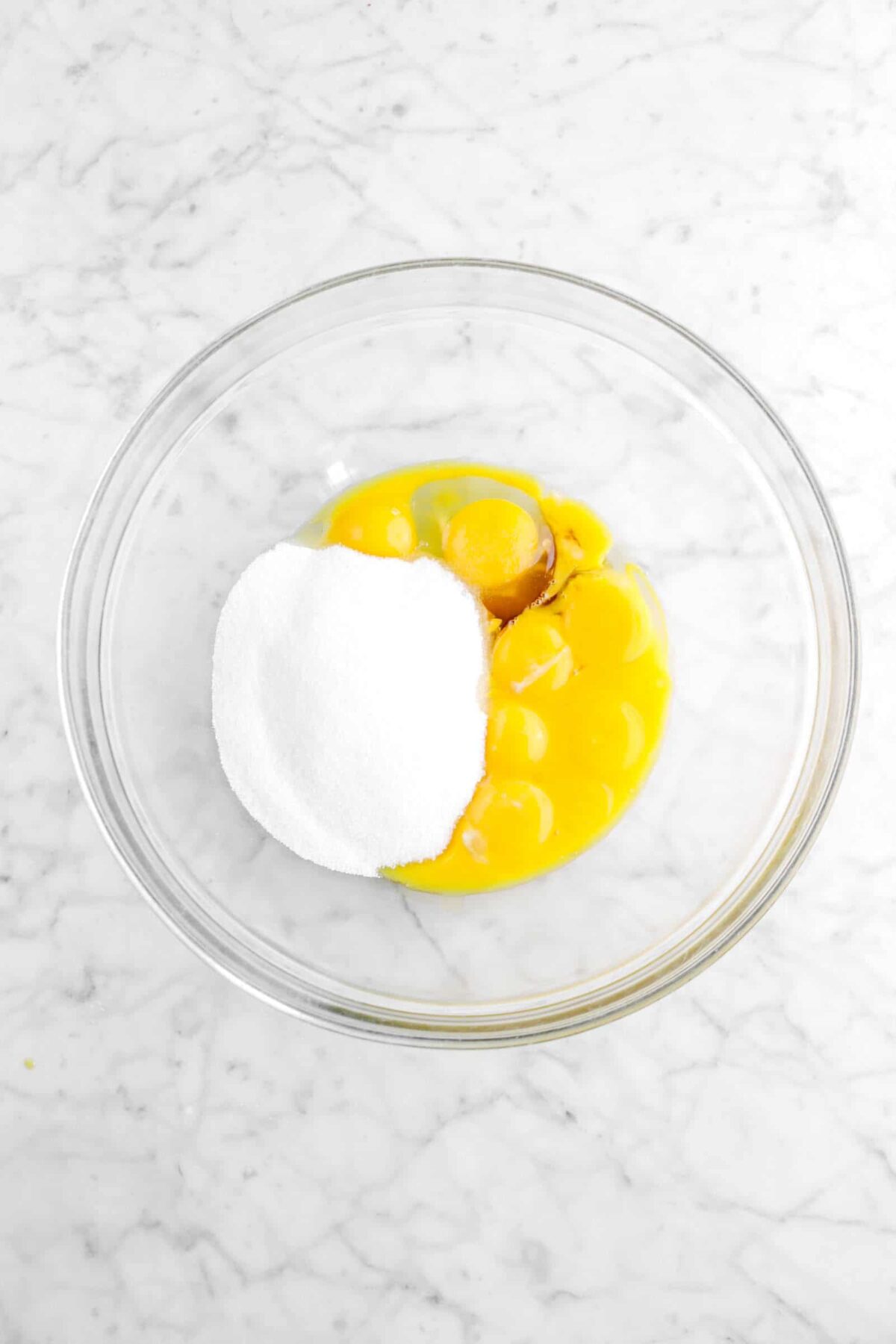 egg yolks, vanilla, and sugar in a glass bowl