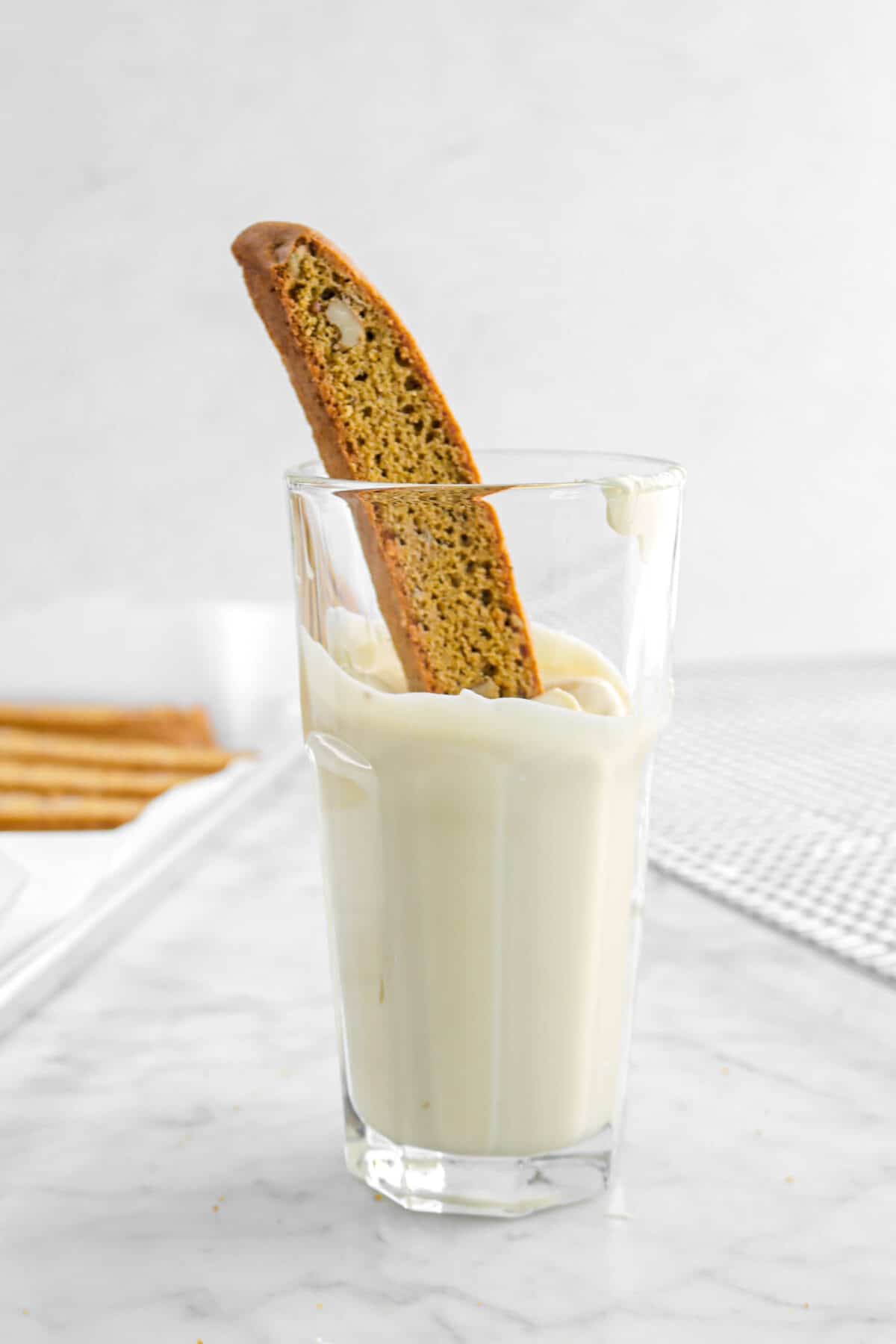biscotti dipped in glass of melted white chocolate