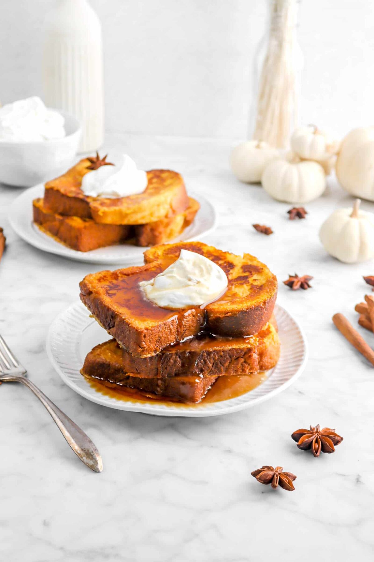 three stacked slices of french toast with star anise around and pumpkins