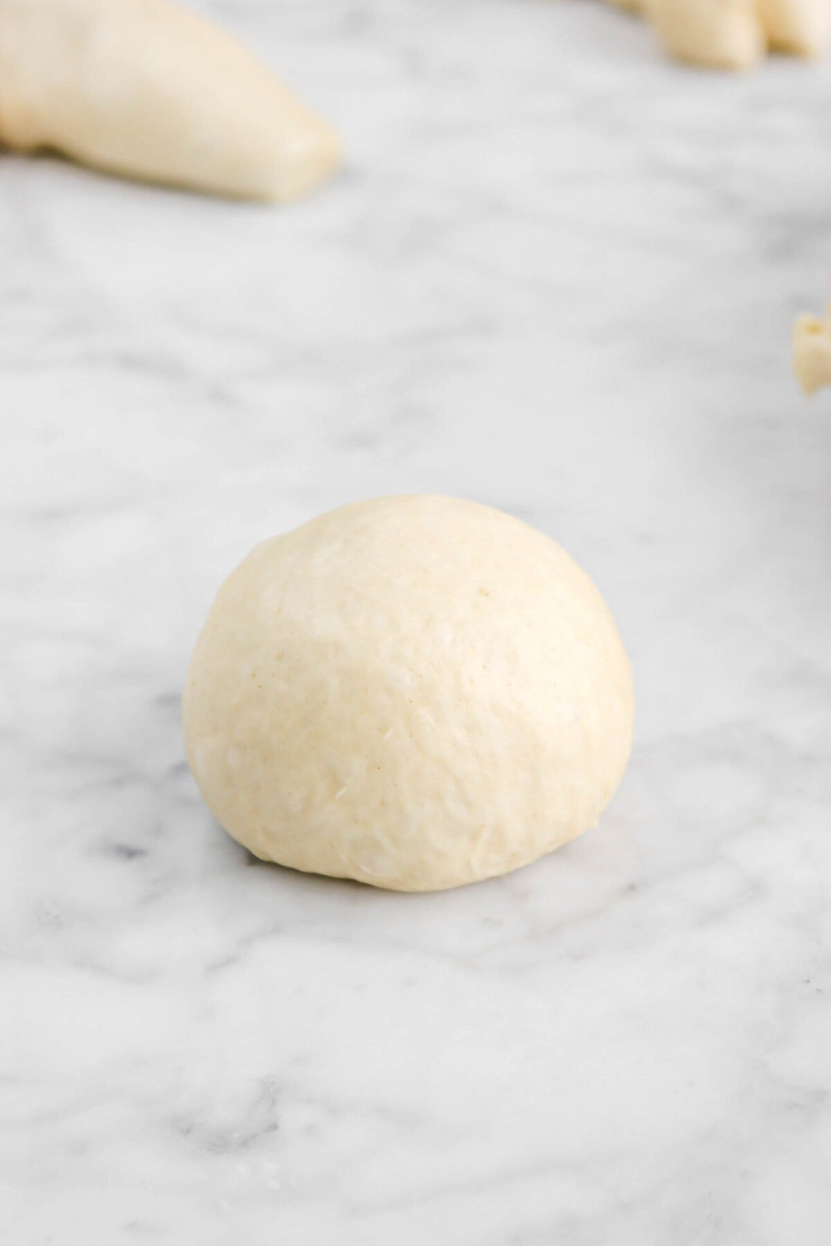 smooth dough ball on marble counter