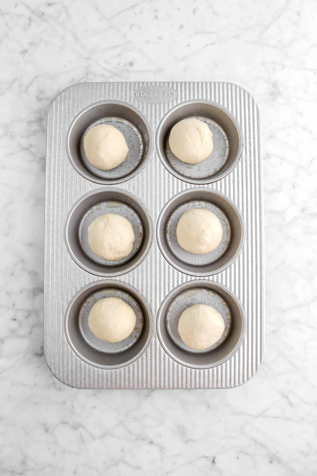 six dough balls in greased pan