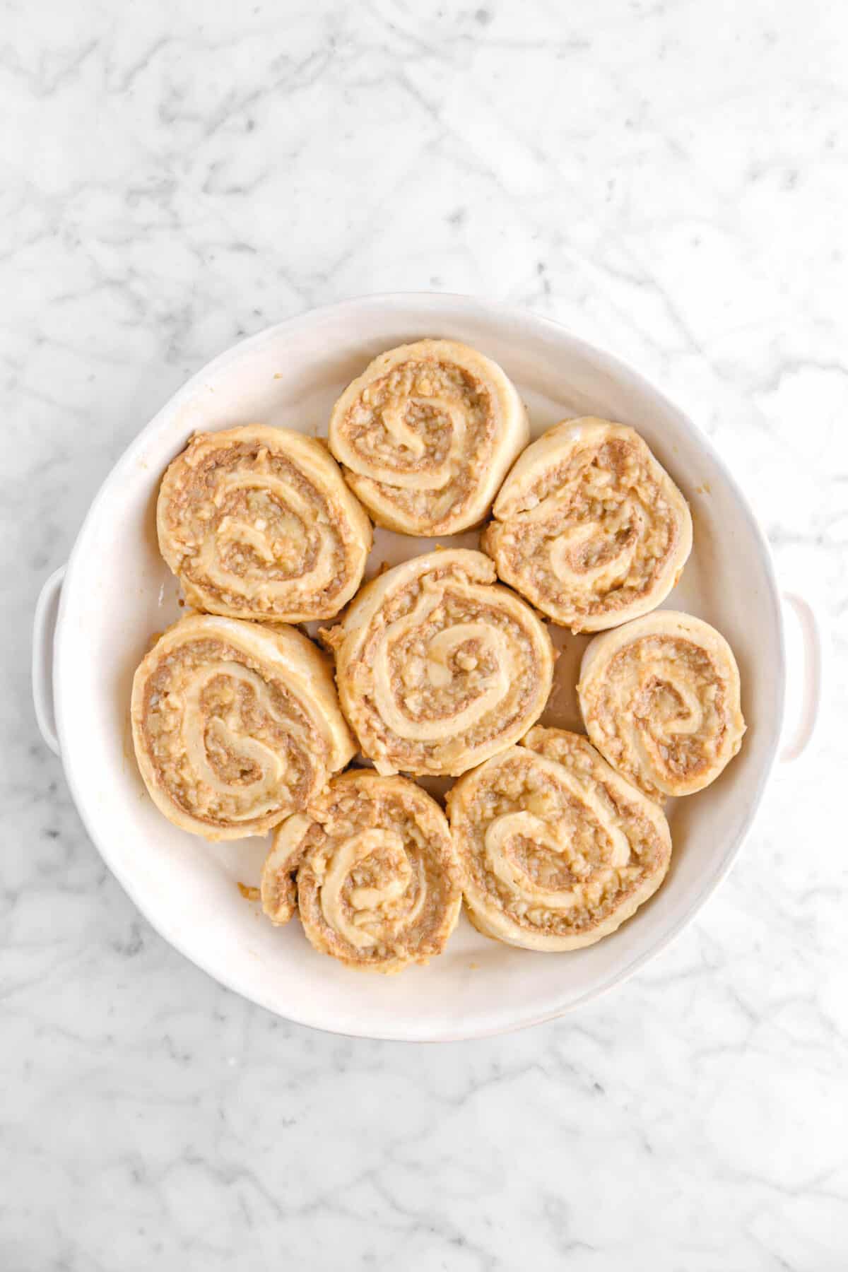 eight apple cinnamon rolls in round baking dish
