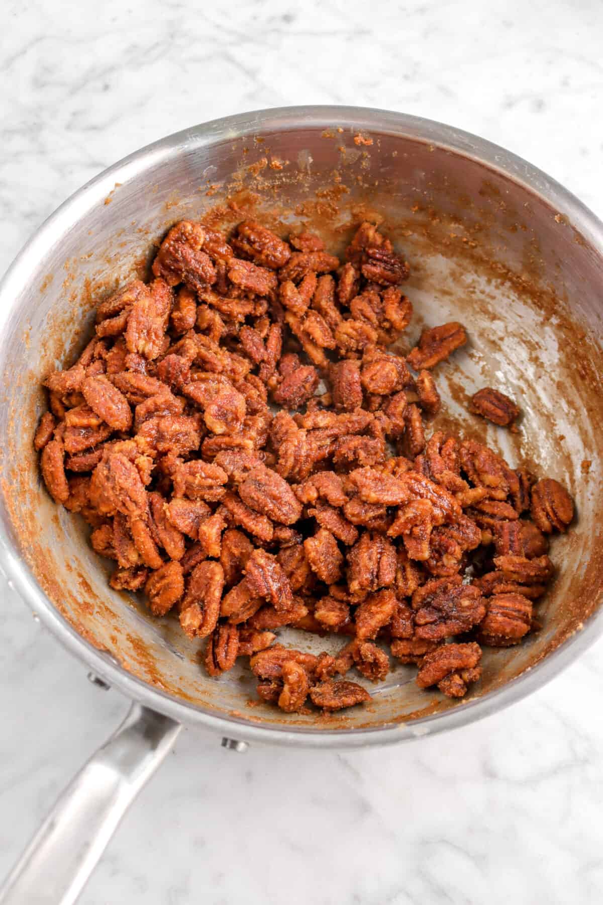 candied pecans in pot on marble counter