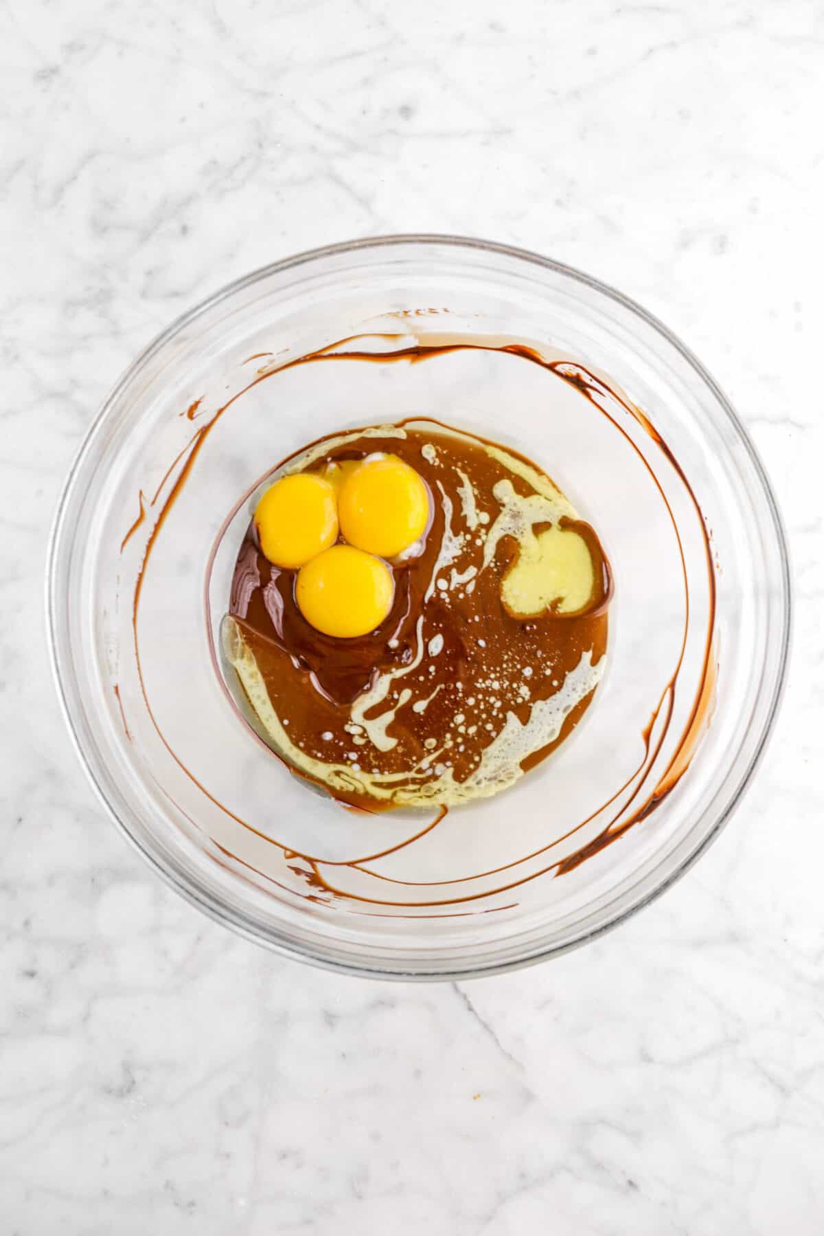 egg yolks and melted butter added to melted chocolate