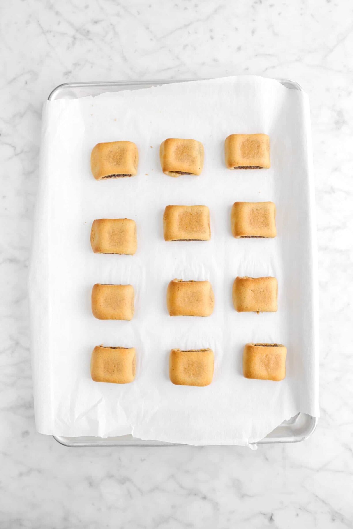 twelve baked fig newtons on lined sheet pan