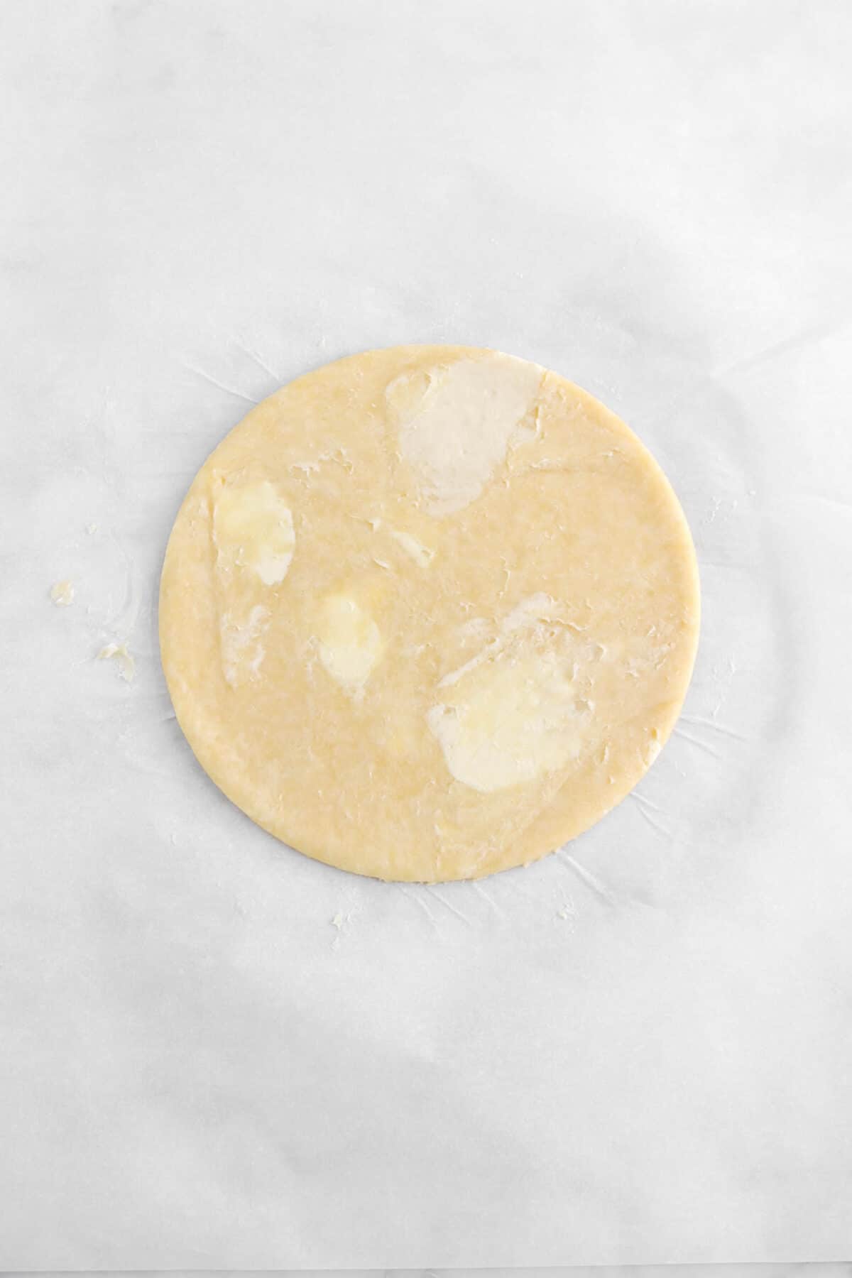 pie dough in a perfect circle on parchment
