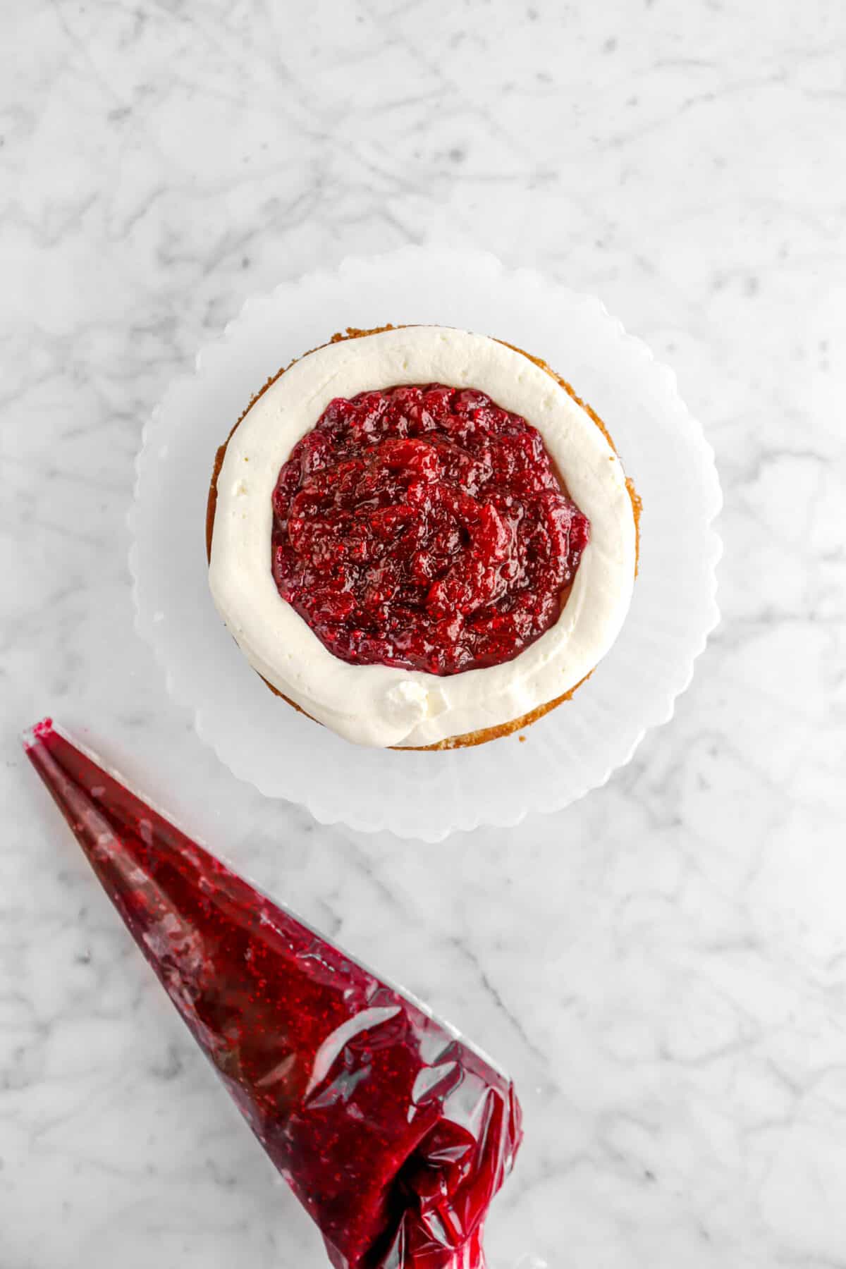 cranberry jam filling inside white chocolate ganache circle