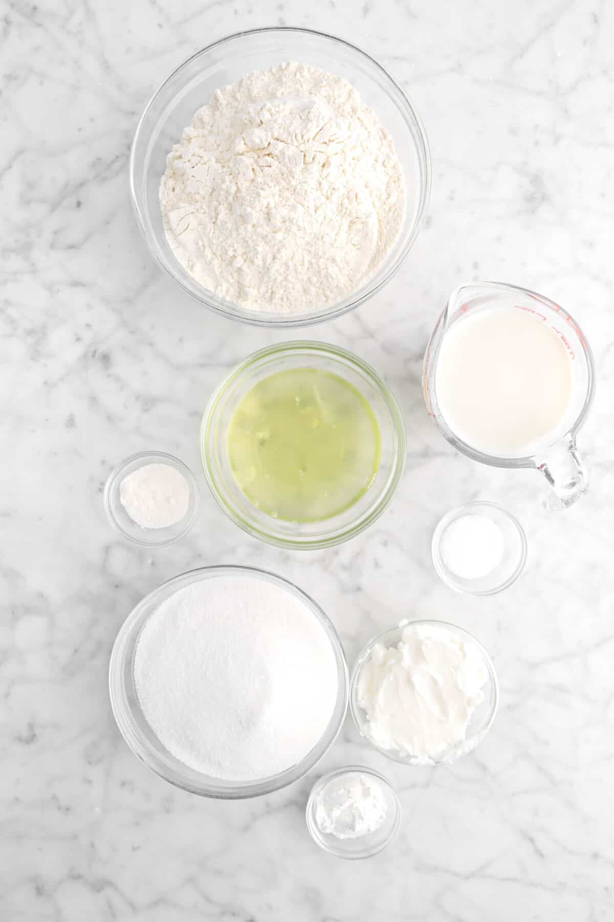 flour, milk, egg whites, vanilla powder, salt, shortening, sugar, and baking powder in glass bowls
