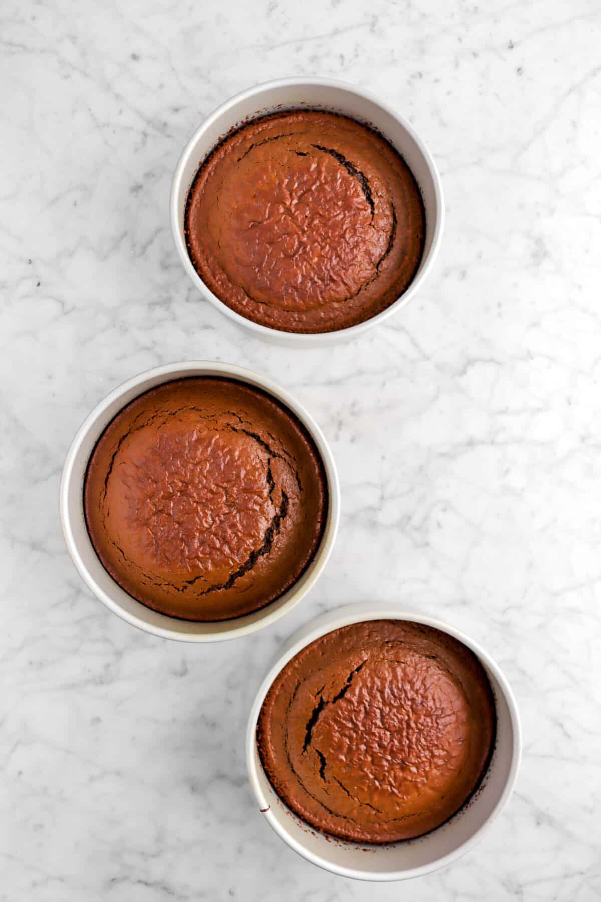 three baked cakes in pans