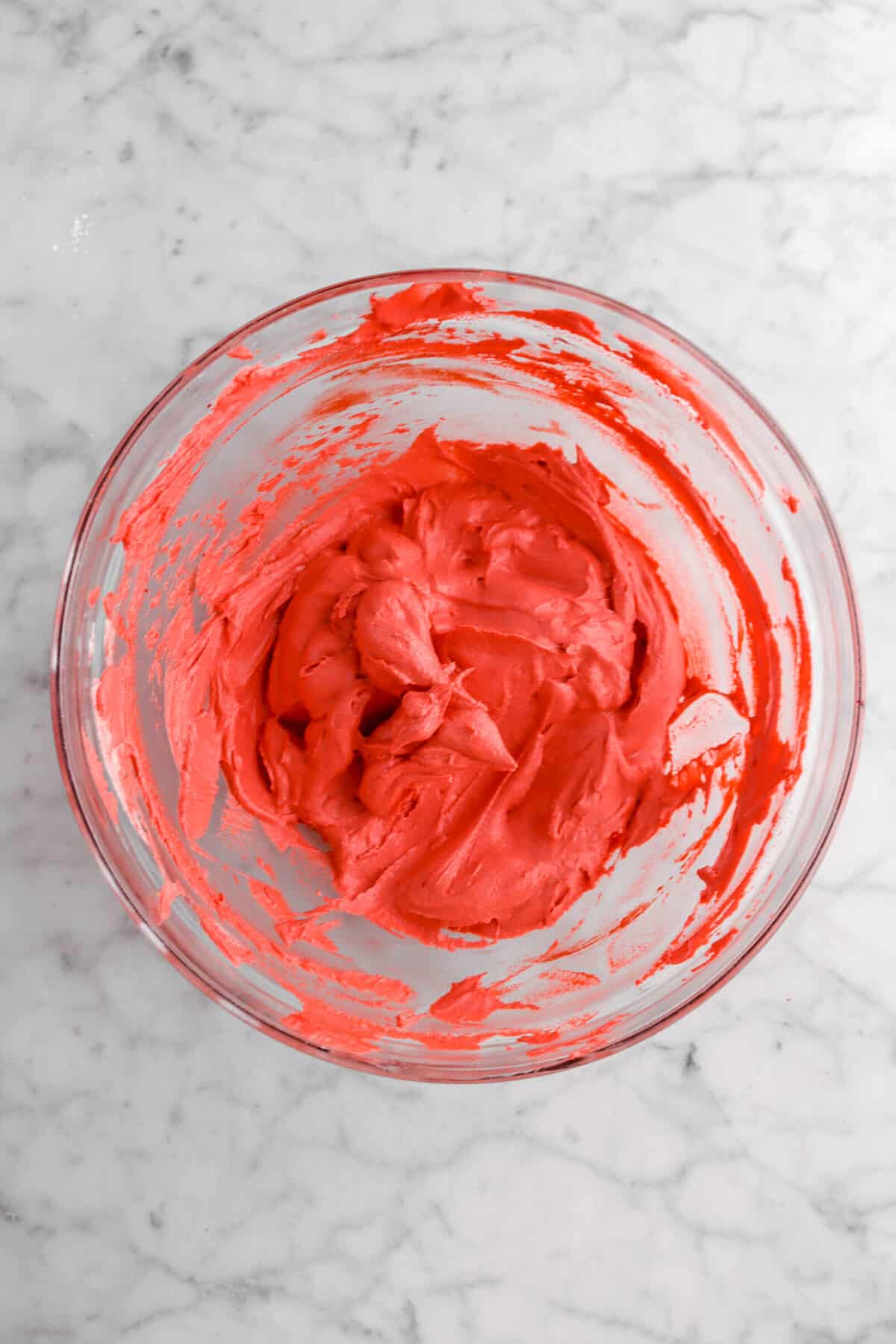 red frosting in glass bowl