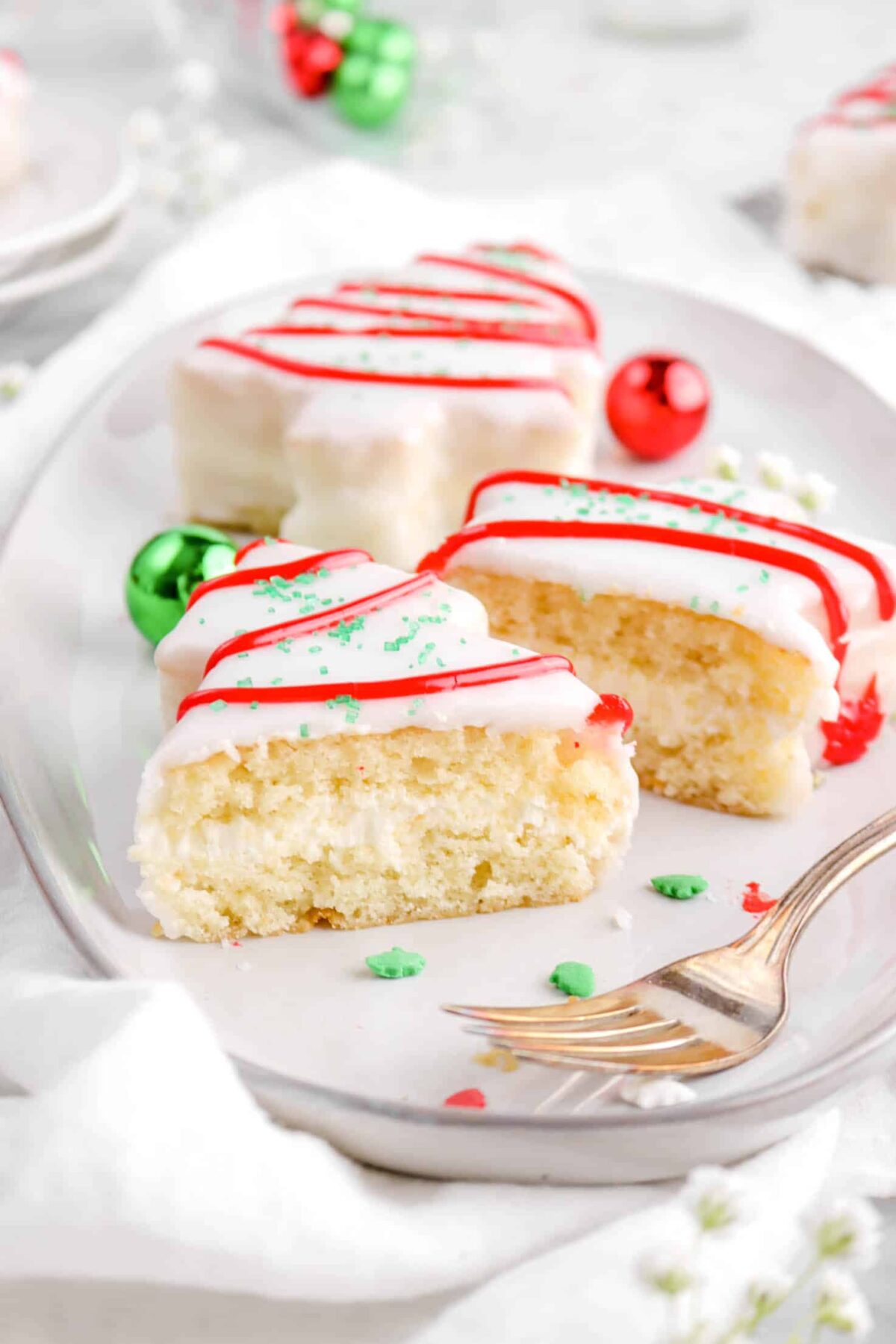 christmas tree cake on plate with fork and sprinkles