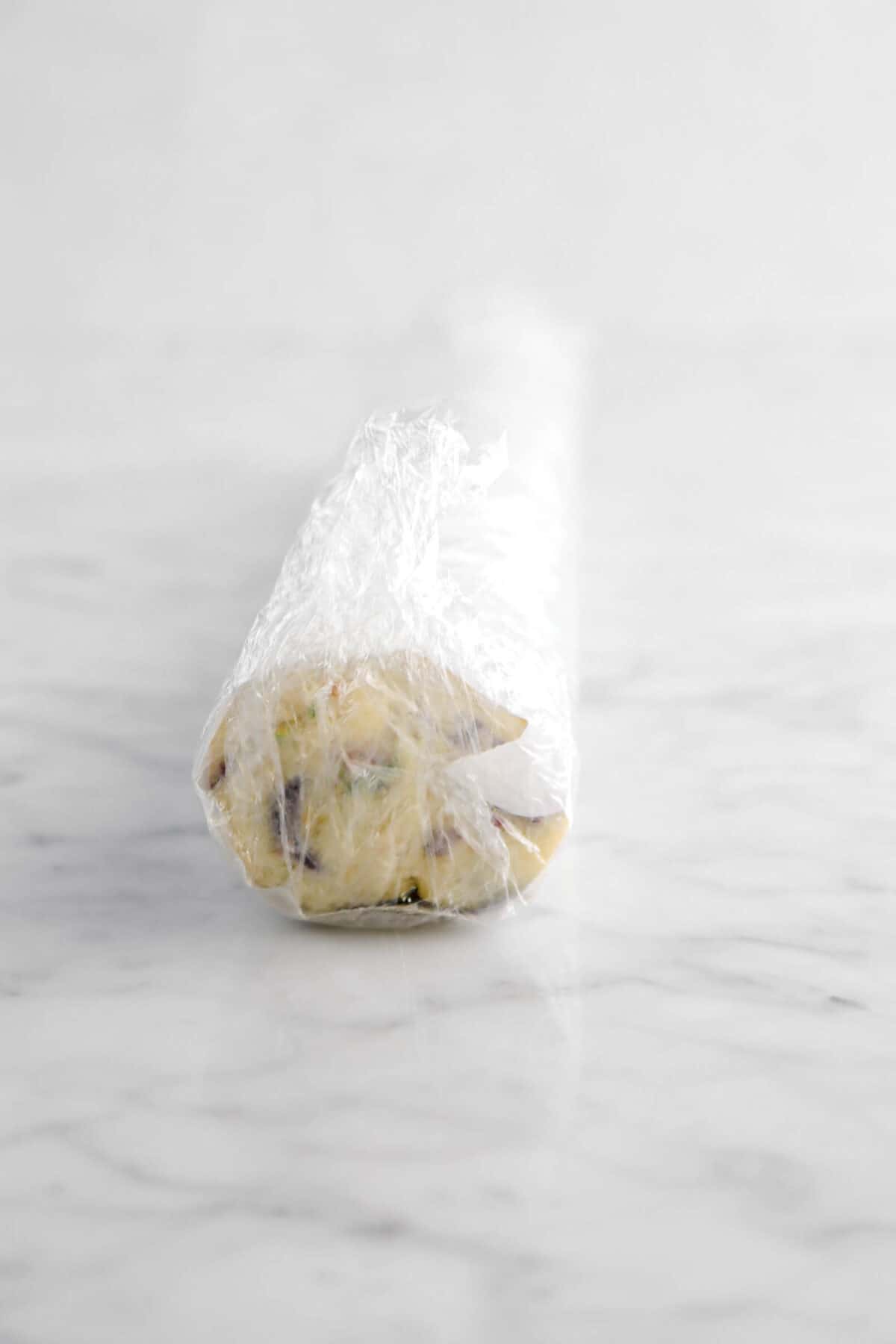 wrapped cookie dough with plastic wrap also around the log