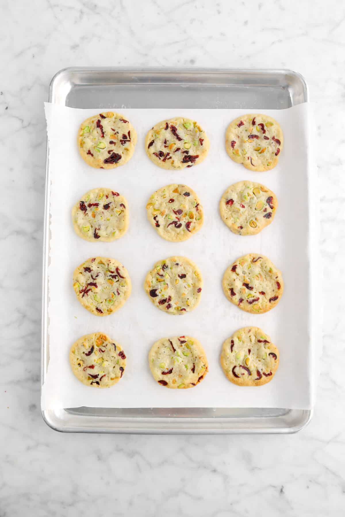 12 baked cookies on lined sheet pan