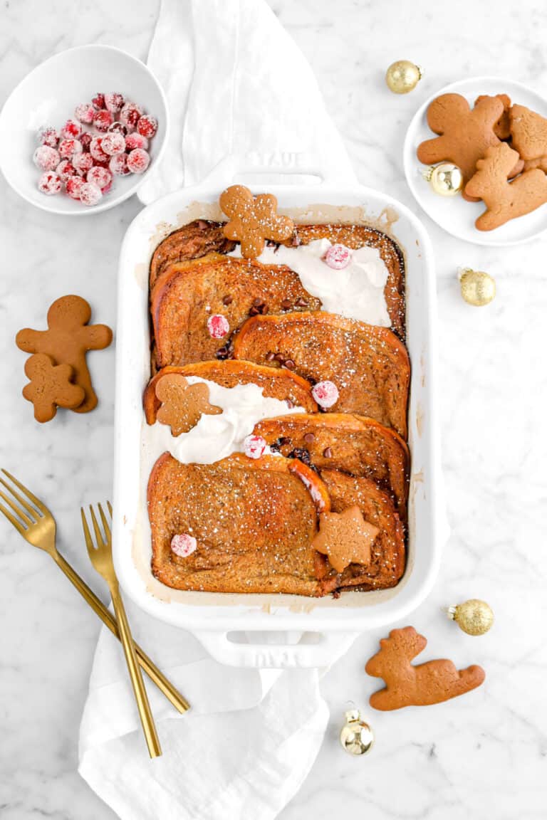 flat lay of gingerbread french toast casserole on white napkin with gingerbread cookies