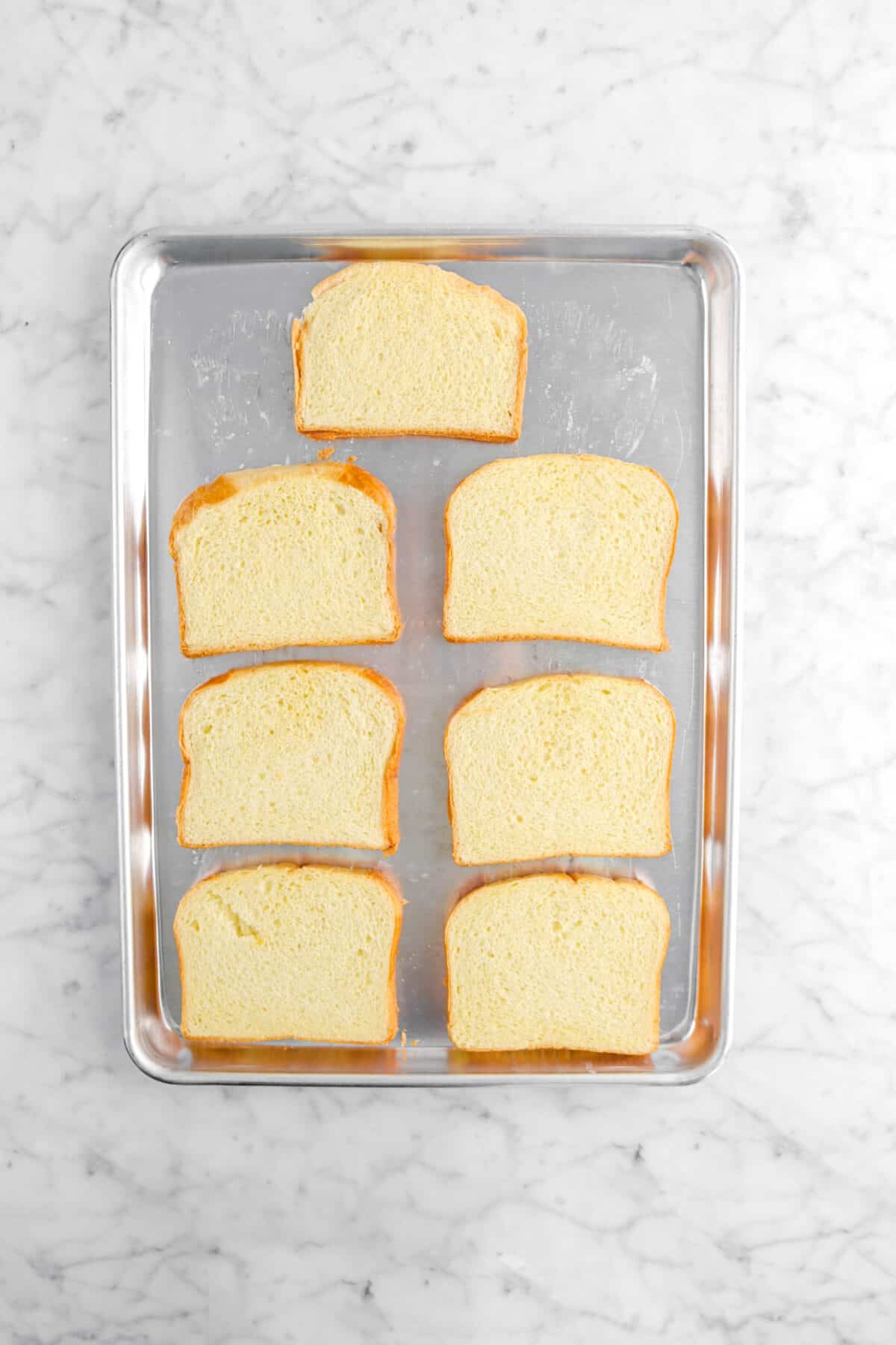 seven pieces of brioche on sheet pan