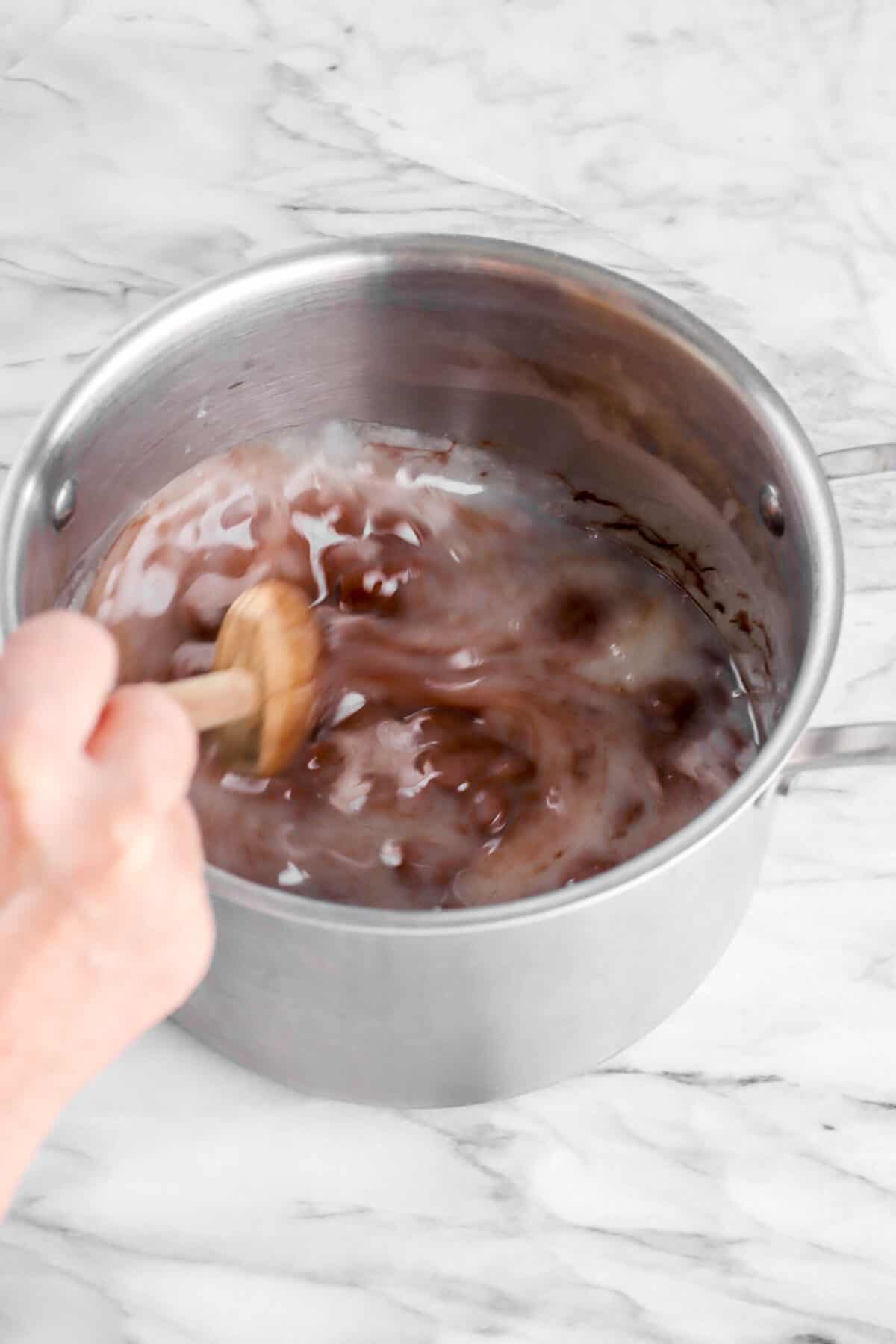 chocolate being stirred into sugar mixture