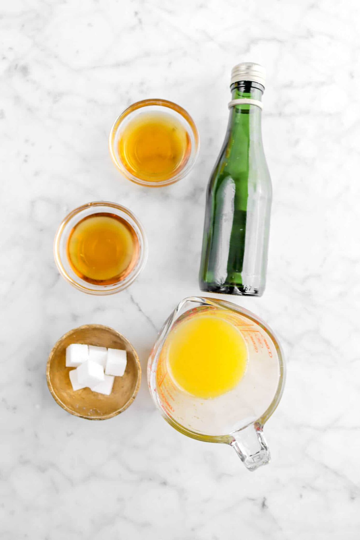 orange liqueur, brandy, sugar cubes, orange juice, and mini bottle of champagne