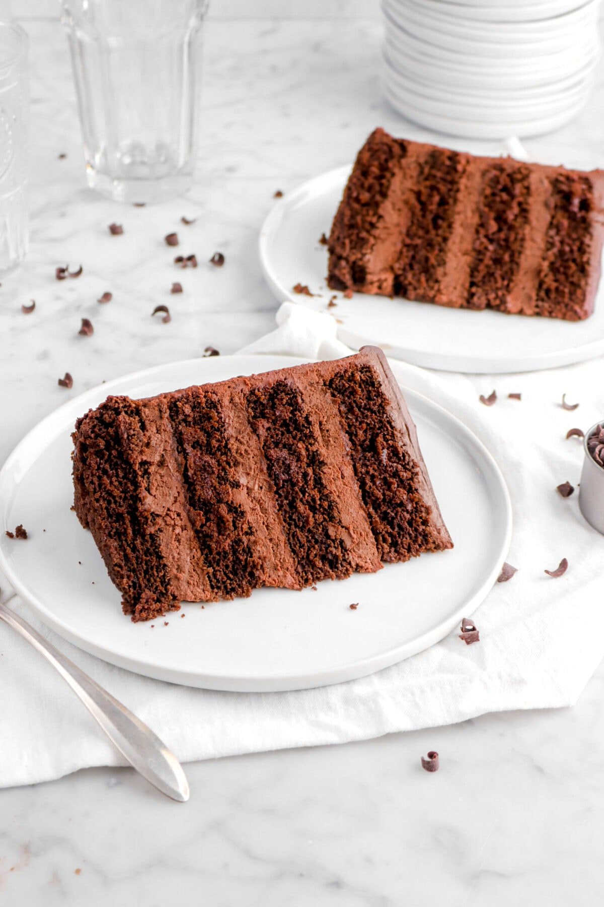 two slices of chocolate cake on white plates