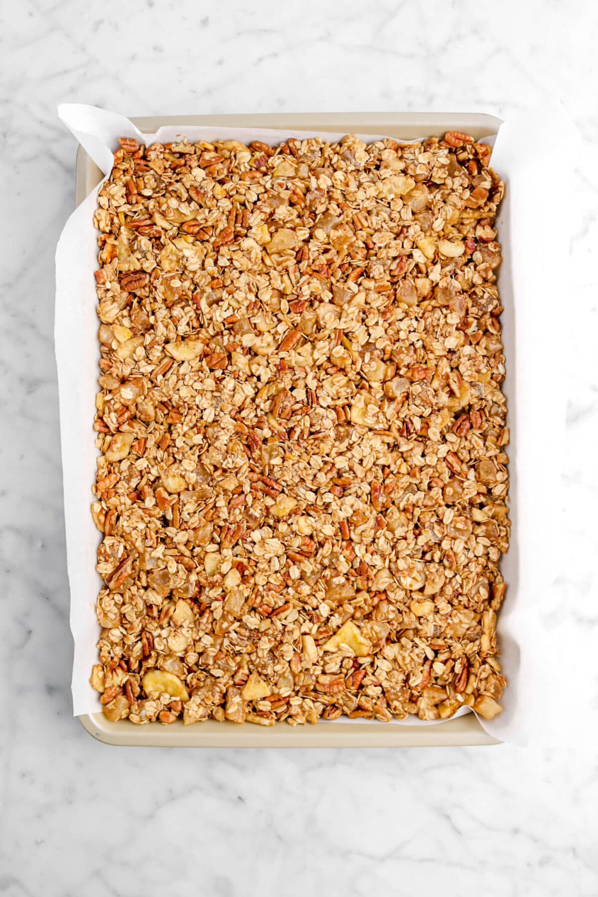 granola compacted down on sheet pan